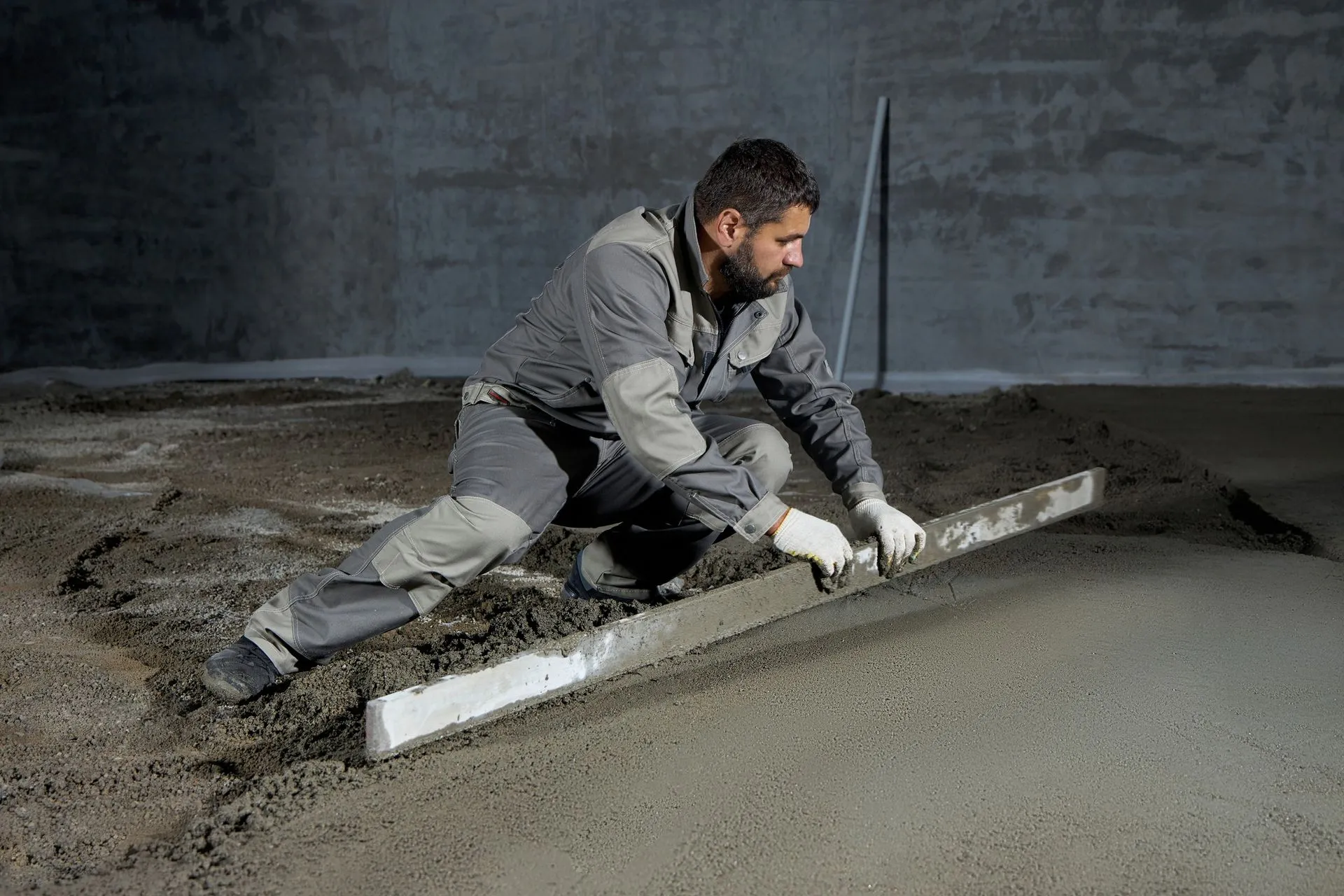 Contractor leveling a poured concrete floor